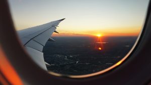 Image of a sunrise from out a an airplane window. 