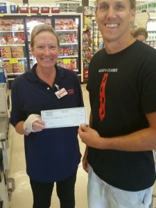 Tyson and Robin with a check from Pioneer Market for Ethos Youth Center