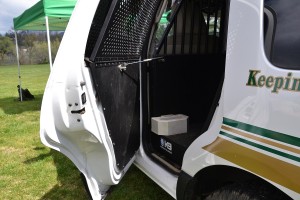 Mechanism that opens rear door of patrol vehicle to let dog out - photo by Gina Clugston