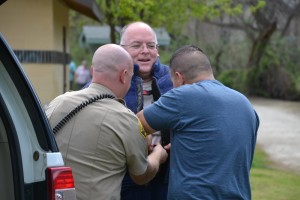 Sheriff Jay Varney gets suited up to get bit - photo by Gina Clugston