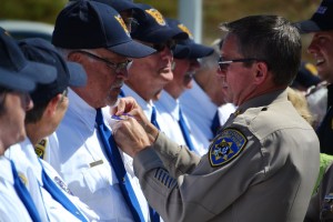 Rich Regert is pinned with badge as CHP Senior Volunteer - photo by Gina Clugston