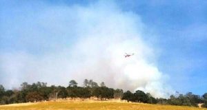 Helicopter dropping water on Gaines fire.