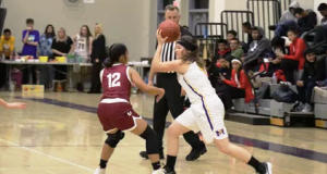 Picture of Junior Makayla Lundgreen taking the ball down the court during the recent Orosi game.