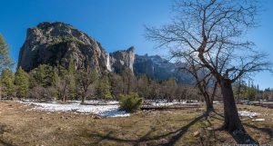 Image of Yosemite Valley's winter snow receding below Bridalveil Fall as spring temperatures approach.