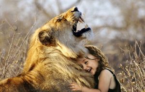 Image of a young girl and a lion. 