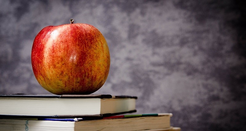 Image of an apple on a stack of books.