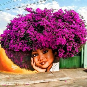 Image of street art by Fabio Gomes Trindade. Woman with purple bougainvillea flowers growing out of her hair.