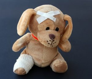 Image of a teddy bear with bandages on. 