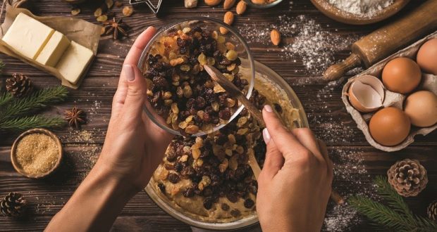 Image of hands serving a bowl of raisins.