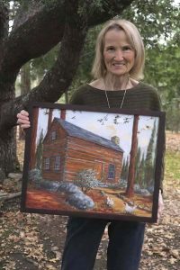 Image of Chel Smith accepting a painting by Mary Beth Harrison.