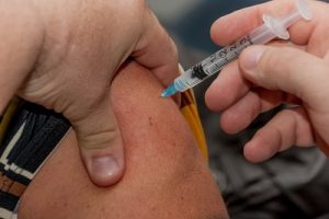 Image of a person getting a flu shot.
