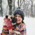 Image of a woman in the snow with her dog.