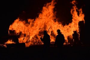 Image of fire fighters in a burning forest.