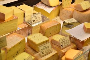 Image of a large selection of cheeses.