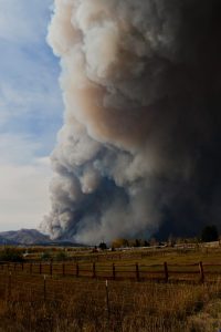 Image of a mountain on fire with a huge plume of smoke.