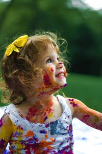 Image of a little girl covered in paint. 