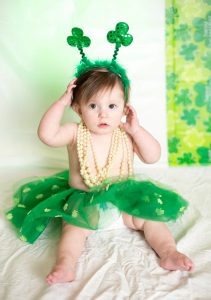 Image of a baby dressed up for St. Patrick's Day. 