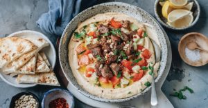 Image of Spiced Grass-Fed Lamb Over Hummus.