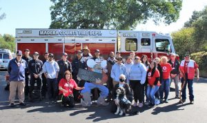 Image of volunteers in front of a fire truck.
