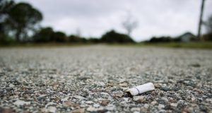 Image of a cigarette butt on an empty street.