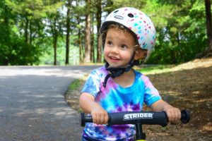 Image of a small child riding a bike.