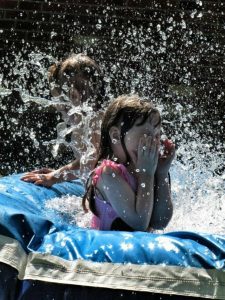 Image of a young girl splashing in the water.