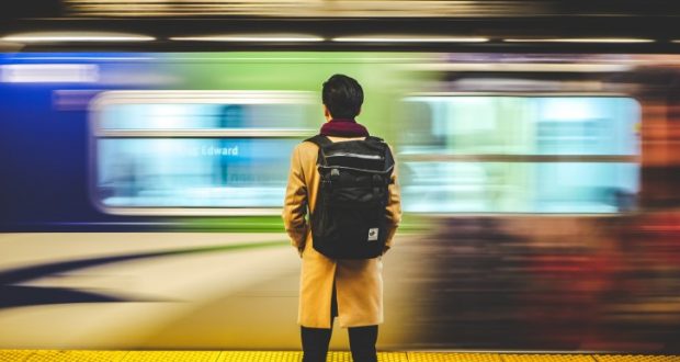 Image of a person standing at a train station.