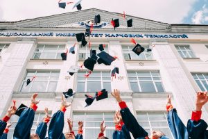 Image of graduates throwing their caps in the air. 