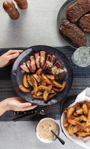 Image of Southwest Steaks with Creamy Peppercorn Sauce and Parmesan-Herb Fries. 