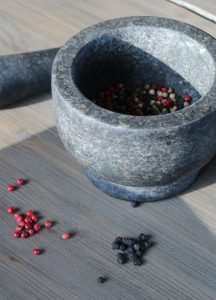 Image of peppercorns in a mortar bowl.
