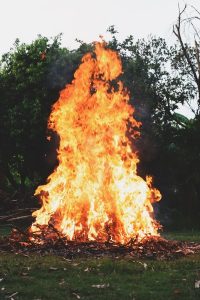 Image of a too large burn pile burning. 