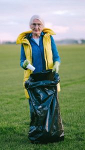 Image of a woman picking up litter. 