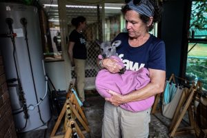 Image of a woman holding a baby wallaby.