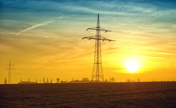 Image of power lines in front of a sunrise. 