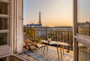 Image of a view of the Eiffel Tower from a balcony window. 