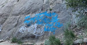 Image of a boulder that has been tagged by vandals. 