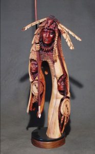 Image of a wooden carving depicting a Native American. 