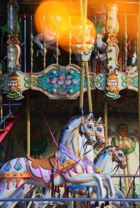 Image of a carousel in an amusement park.