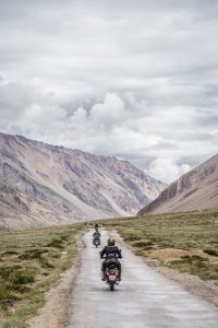 Image of two people riding motorcycles through the Himalayas. 