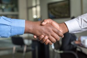 Image of two people shaking hands.