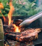 Image of a steak being grilled.