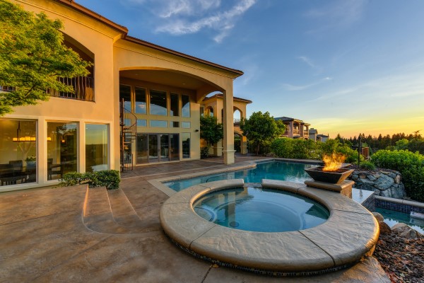 Image of a backyard deck with pool and jacuzzi. 