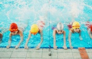 Image of little children being given swim lessons.