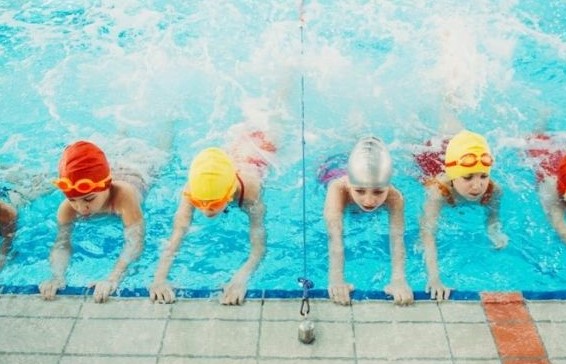 Image of little children being given swim lessons. 