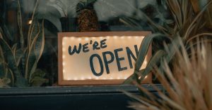 Image of a "We're Open" sign.