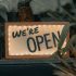 Image of a "We're Open" sign.