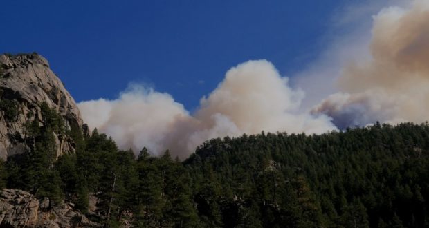 Image of a forest fire on the other side of a mountain.