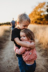 Image of a young boy and girl hugging. 