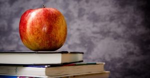 Image of an apple on a stack of books.