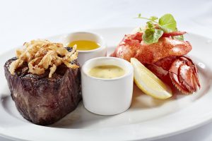 Image of a plate featuring steak and crab